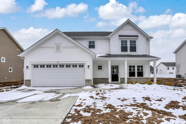 modern inspired farmhouse featuring stone siding, central AC unit, board and batten siding, and an attached garage