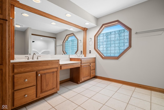 full bath with double vanity, baseboards, tile patterned flooring, a sink, and recessed lighting