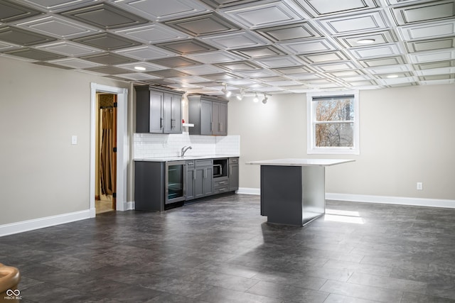 bar featuring an ornate ceiling and baseboards