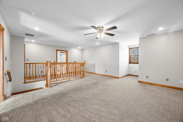 carpeted empty room with recessed lighting, visible vents, and baseboards