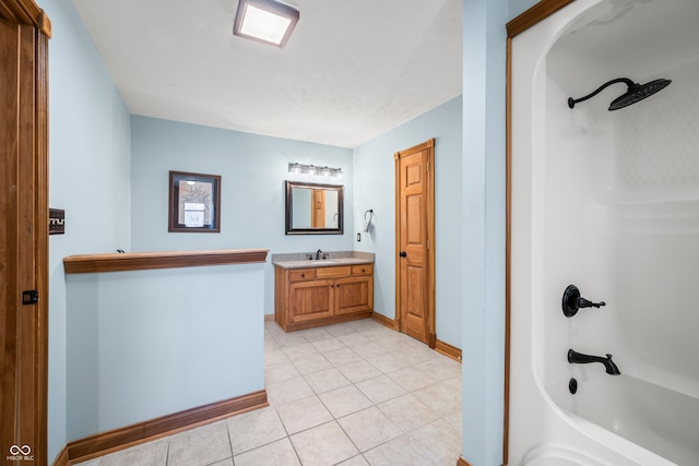 bathroom featuring shower / bath combination, tile patterned flooring, baseboards, and vanity