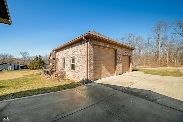 exterior space with a garage, a lawn, and brick siding