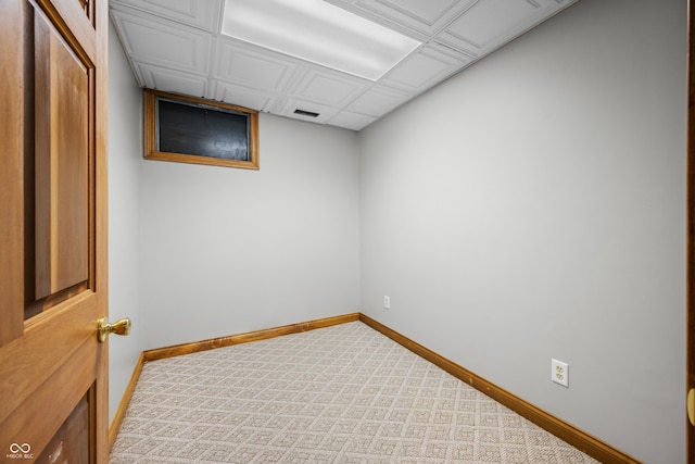 carpeted spare room featuring visible vents and baseboards