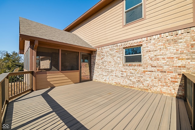 wooden deck with a sunroom