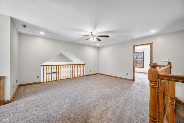 carpeted spare room featuring ceiling fan, recessed lighting, and baseboards