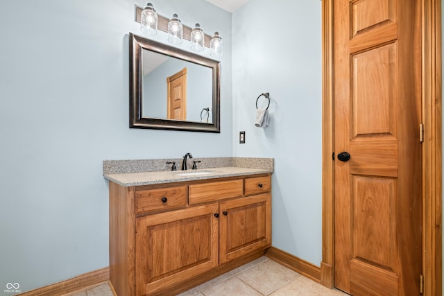 bathroom featuring tile patterned flooring, baseboards, and vanity