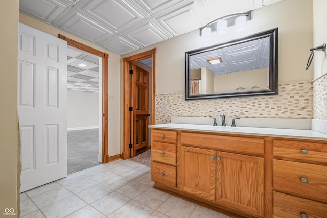 bathroom with tasteful backsplash, vanity, an ornate ceiling, and baseboards