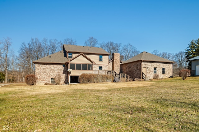 back of property featuring a sunroom and a yard