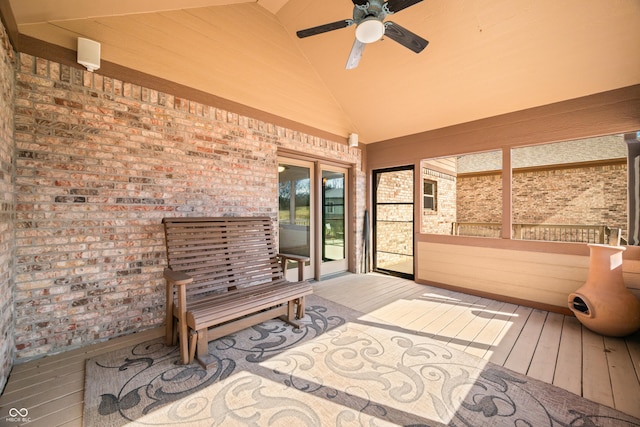 sunroom / solarium with ceiling fan and vaulted ceiling