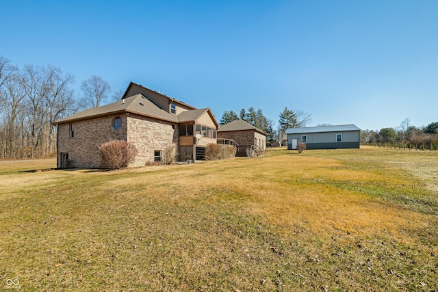 view of property exterior with brick siding and a lawn