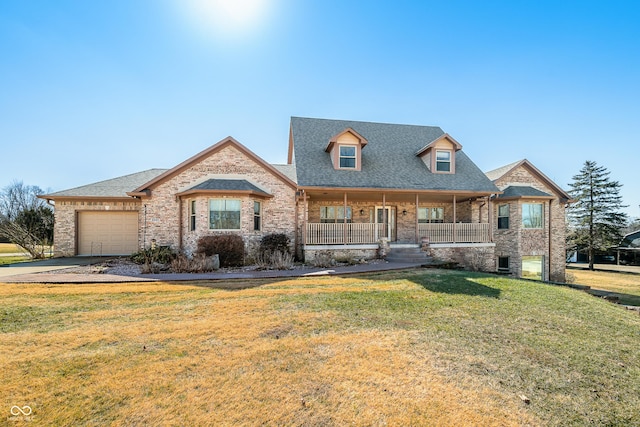 view of front of house featuring a porch, a garage, brick siding, concrete driveway, and a front lawn