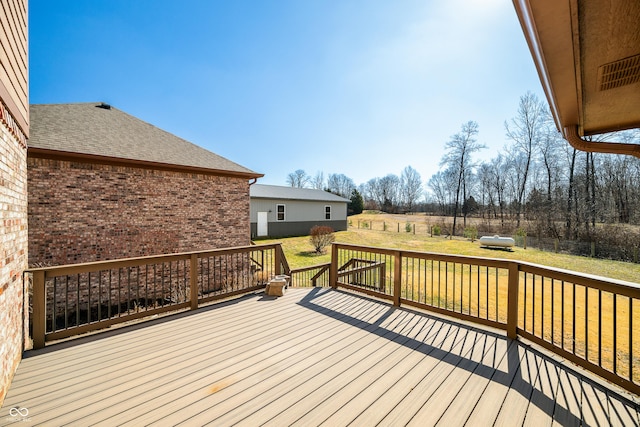 deck with a yard and fence