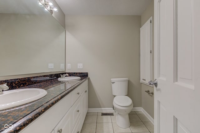 bathroom with double vanity, tile patterned flooring, a sink, and visible vents