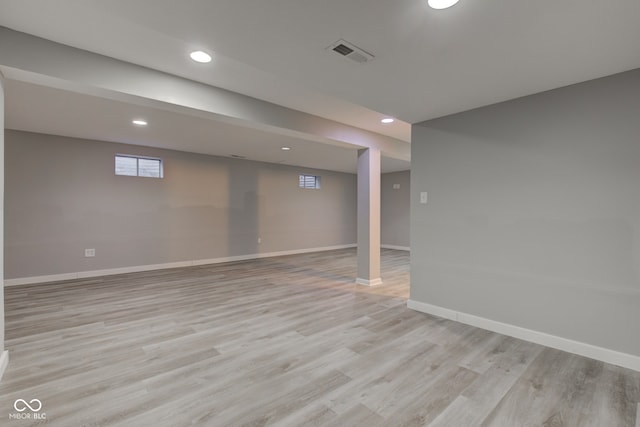 below grade area featuring recessed lighting, baseboards, visible vents, and light wood finished floors