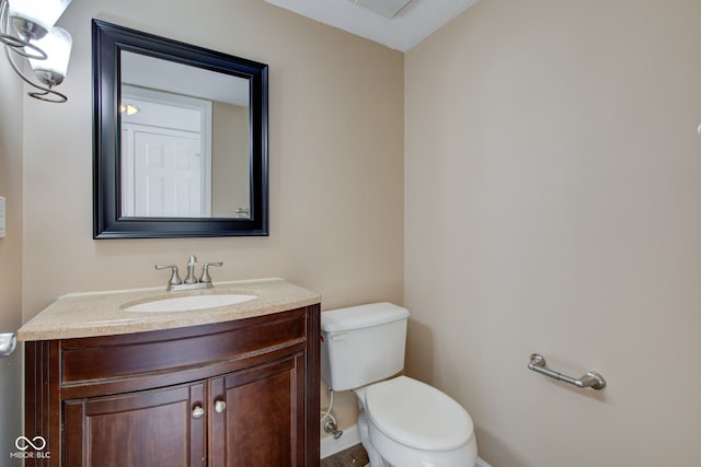 bathroom featuring toilet and vanity