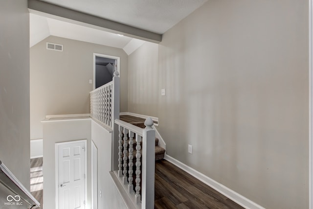 staircase featuring vaulted ceiling with beams, baseboards, visible vents, and wood finished floors