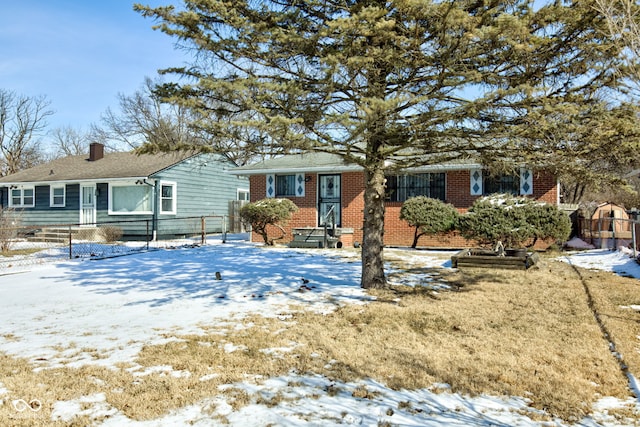 ranch-style house featuring brick siding