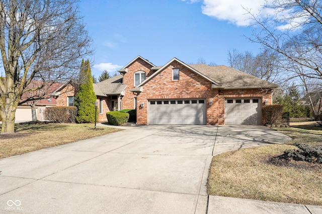 traditional home with an attached garage, a shingled roof, concrete driveway, and brick siding