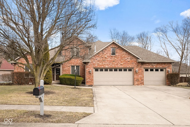 traditional-style house featuring brick siding, a shingled roof, an attached garage, driveway, and a front lawn