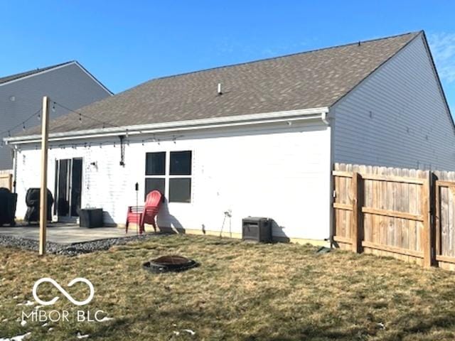 back of house with a patio area, fence, and a lawn