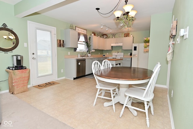 dining room with a notable chandelier and baseboards