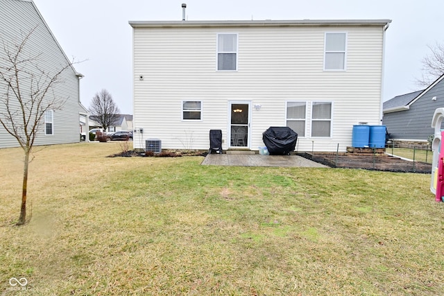 back of property with a yard, a patio area, and cooling unit