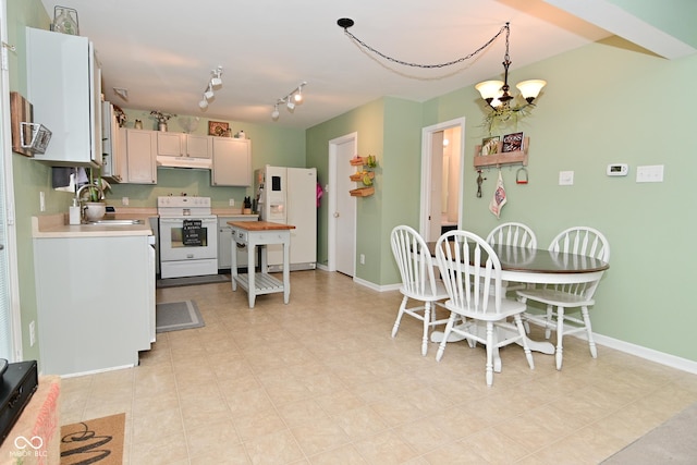 kitchen with light countertops, a sink, white appliances, under cabinet range hood, and baseboards