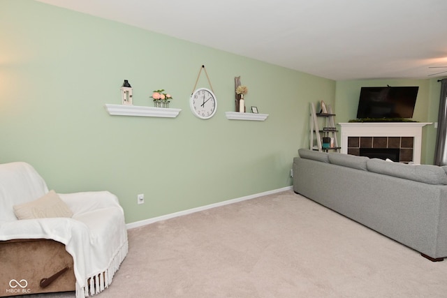 interior space with carpet floors, baseboards, and a tiled fireplace