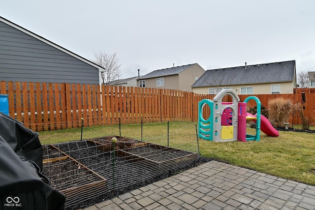 view of jungle gym with a fenced backyard and a lawn