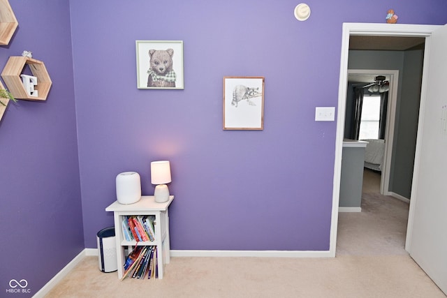 recreation room with carpet and baseboards