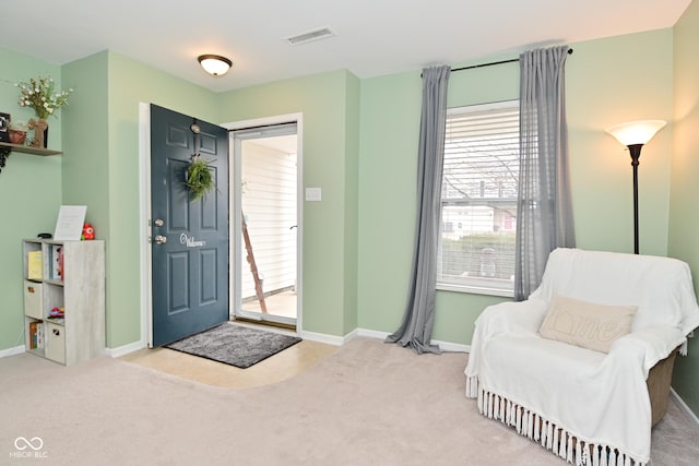 entryway featuring carpet flooring, visible vents, and baseboards