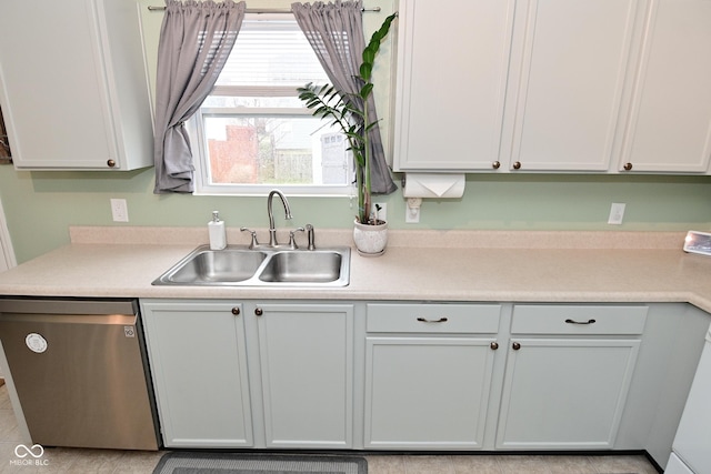 kitchen with a sink, light countertops, and dishwasher