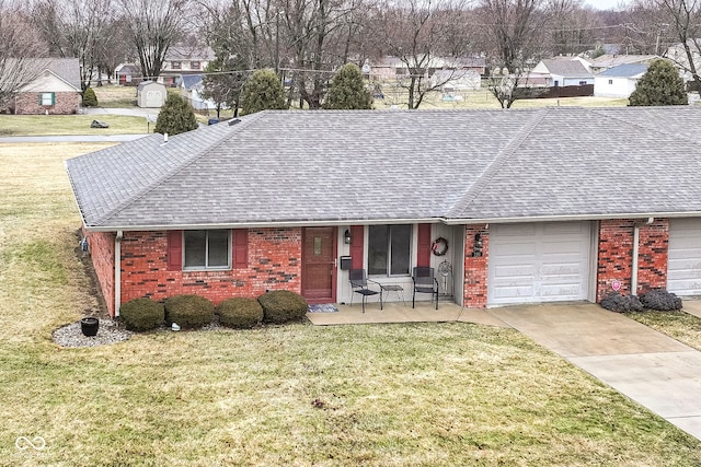 single story home featuring brick siding, roof with shingles, concrete driveway, a garage, and a front lawn