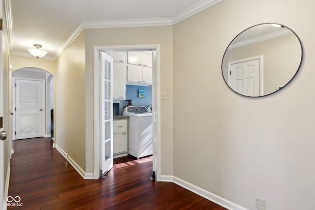 hall with washer / dryer, crown molding, baseboards, and dark wood-style flooring