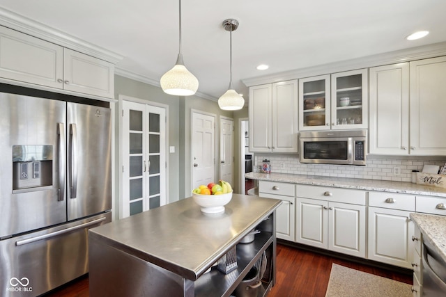 kitchen with hanging light fixtures, open shelves, white cabinetry, and stainless steel appliances