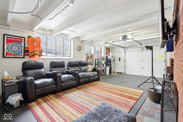 garage with a garage door opener and concrete block wall