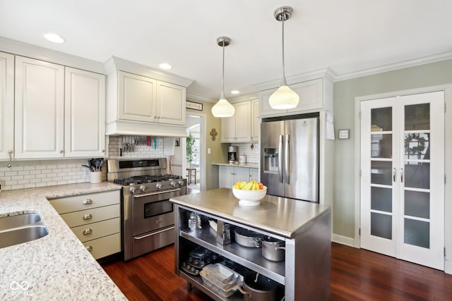 kitchen featuring stainless steel appliances, hanging light fixtures, ornamental molding, light stone countertops, and dark wood-style floors