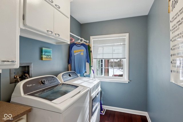 washroom with dark wood-style floors, cabinet space, washer and clothes dryer, and baseboards