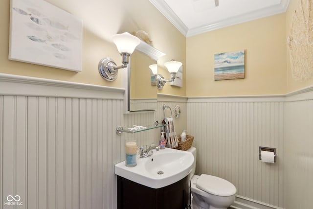 bathroom with visible vents, toilet, a wainscoted wall, ornamental molding, and vanity