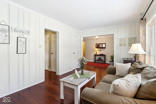 living room featuring baseboards, ornamental molding, and dark wood-type flooring