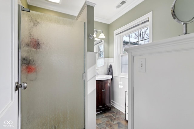 full bathroom featuring visible vents, crown molding, vanity, and a shower stall