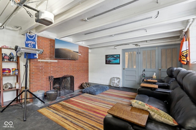 living area with concrete floors, a brick fireplace, and concrete block wall