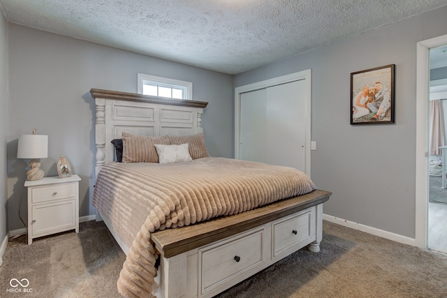 bedroom with baseboards, a closet, dark carpet, and a textured ceiling