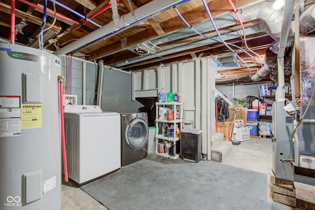 unfinished below grade area featuring water heater and washing machine and clothes dryer