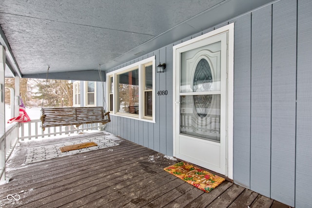 wooden terrace featuring covered porch