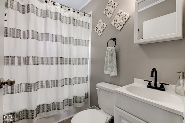 bathroom with curtained shower, vanity, and toilet