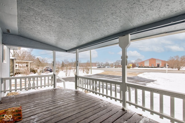 snow covered deck with visible vents