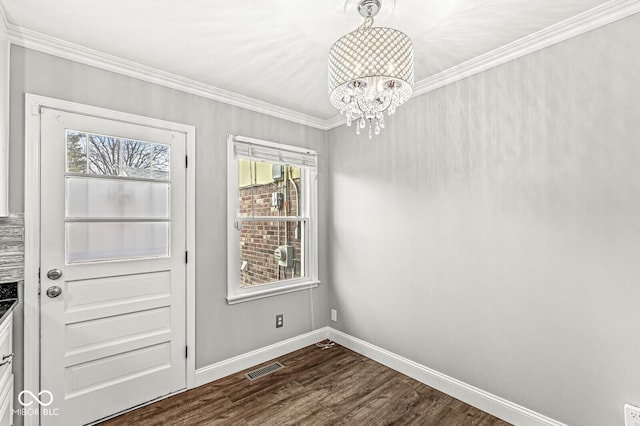 unfurnished dining area with dark wood-style floors, ornamental molding, plenty of natural light, and visible vents