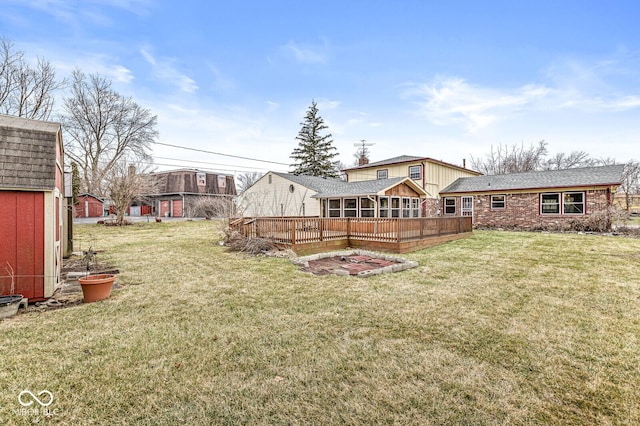 view of yard with an outdoor structure and a wooden deck