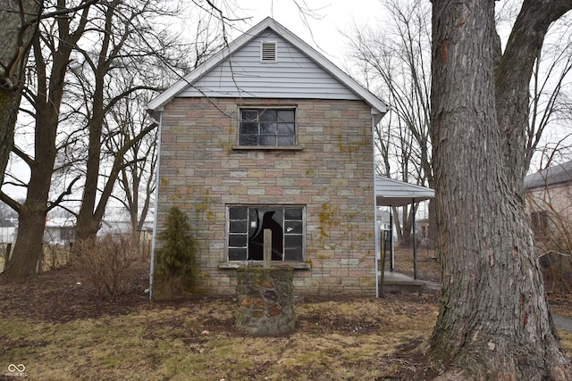 view of side of property featuring stone siding